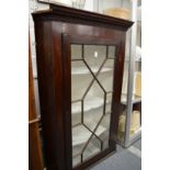 A mahogany hanging corner cupboard.