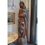 A large carved and painted wooden standing figure of Mary and the Infant Jesus.