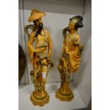 A pair of resin oriental figures.