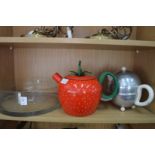 A glass bowl and two novelty teapots.