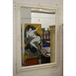 A wall mirror with white painted frame.