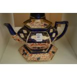 A lustre teapot on stand.