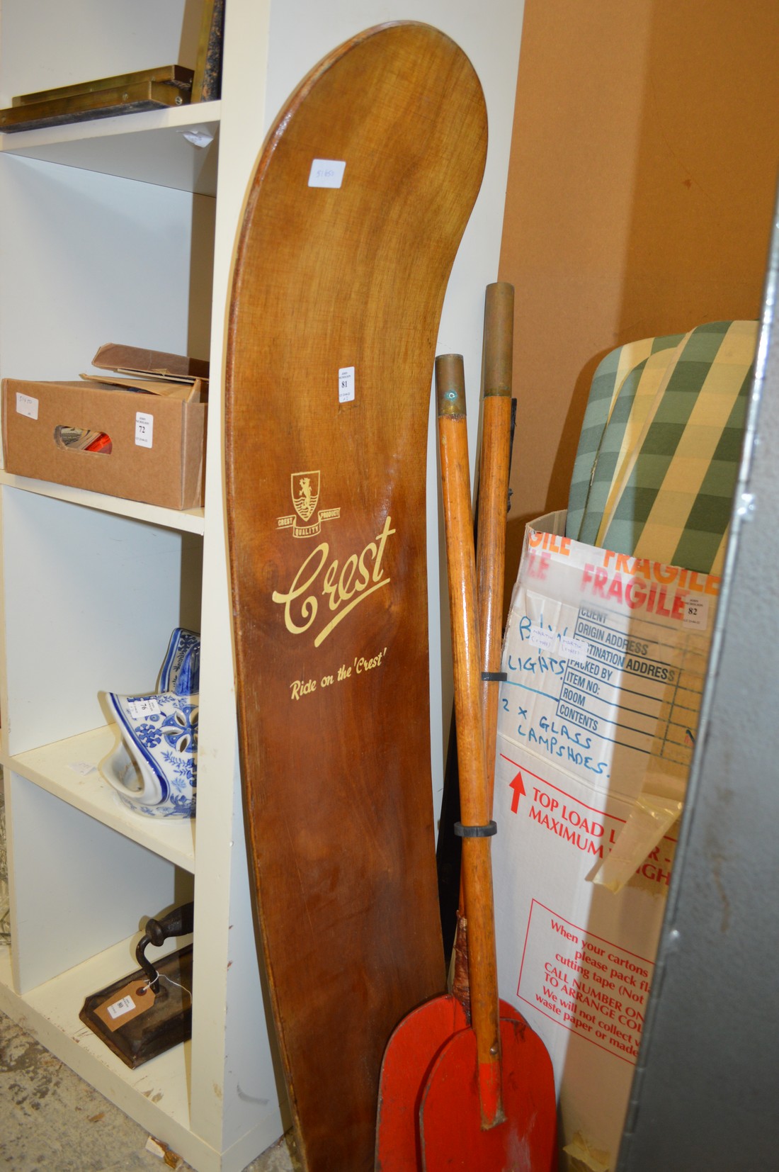 A Crest early bodyboard with a pair of paddles.