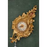 A miniature ormolu cartel clock.