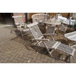 A good pair of teak steamer armchairs.