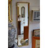 A gilt framed dressing mirror.