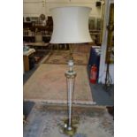An ornate Adam revival floor standing lamp with shade.