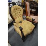 A Victorian carved rosewood framed button upholstered open armchair.