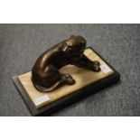 An Art Deco spelter model of a panther on a rectangular marble base.