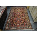 A Persian rug with large floral decoration.