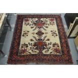 An unusual cream ground Persian rug.