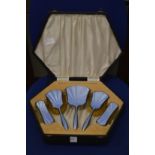 A cased silver and enamel dressing table set.