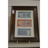 Three framed banknotes.