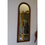 A pair of mahogany arch shaped mirrors.