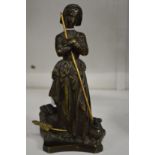 A good small bronze figure of a women with a dog by her side.