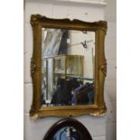 A gilt framed mirror.