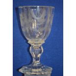 An engraved glass goblet (small rim chip).