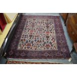 A Persian rug, cream ground with stylized decoration.