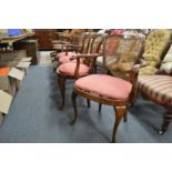 A set of four beech framed cane back dining chairs, two with arms.