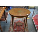 An Edwardian inlaid and painted mahogany oval occasional table.