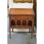 A Liberty & Co walnut bureau with a single drawer over an arcaded undertier (drawer with Liberty