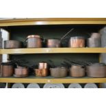 A comprehensive collection of Victorian copper saucepans, cooking pots etc.