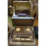 Two old reel to reel tape players.