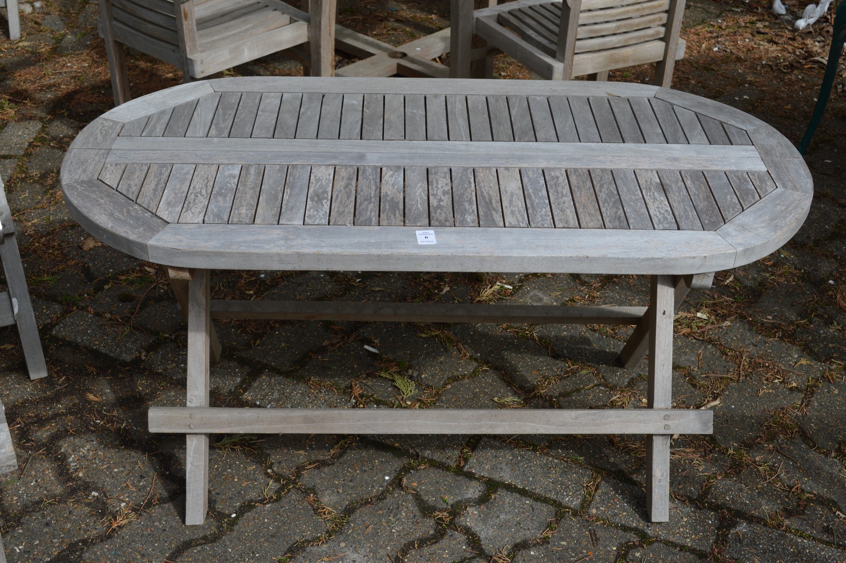 A small hardwood folding oval garden table.