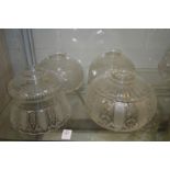 Four cut glass lampshades.