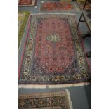 A Persian pink ground rug.