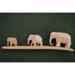 Three carved elephants.