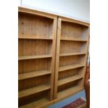 A pair of pine standing open bookcases.