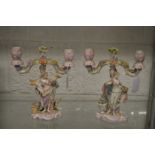 A good pair of porcelain figural twin branch candelabra.