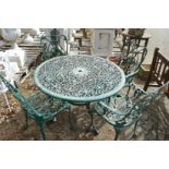 A green painted aluminium circular garden table with four armchairs.