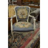 A French style cream painted and needlework upholstered open armchair.