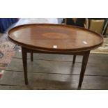 A mahogany and inlaid oval tray table.