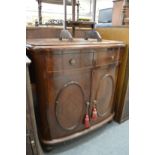 A mahogany bow front cupboard with two drawers.