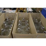 A large quantity of clear glass lampshades.