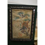 An early Chinese embroidered panel mounted in a mother-of-pearl inlaid hardwood frame.