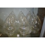 Nine teardrop shaped clear lampshades.