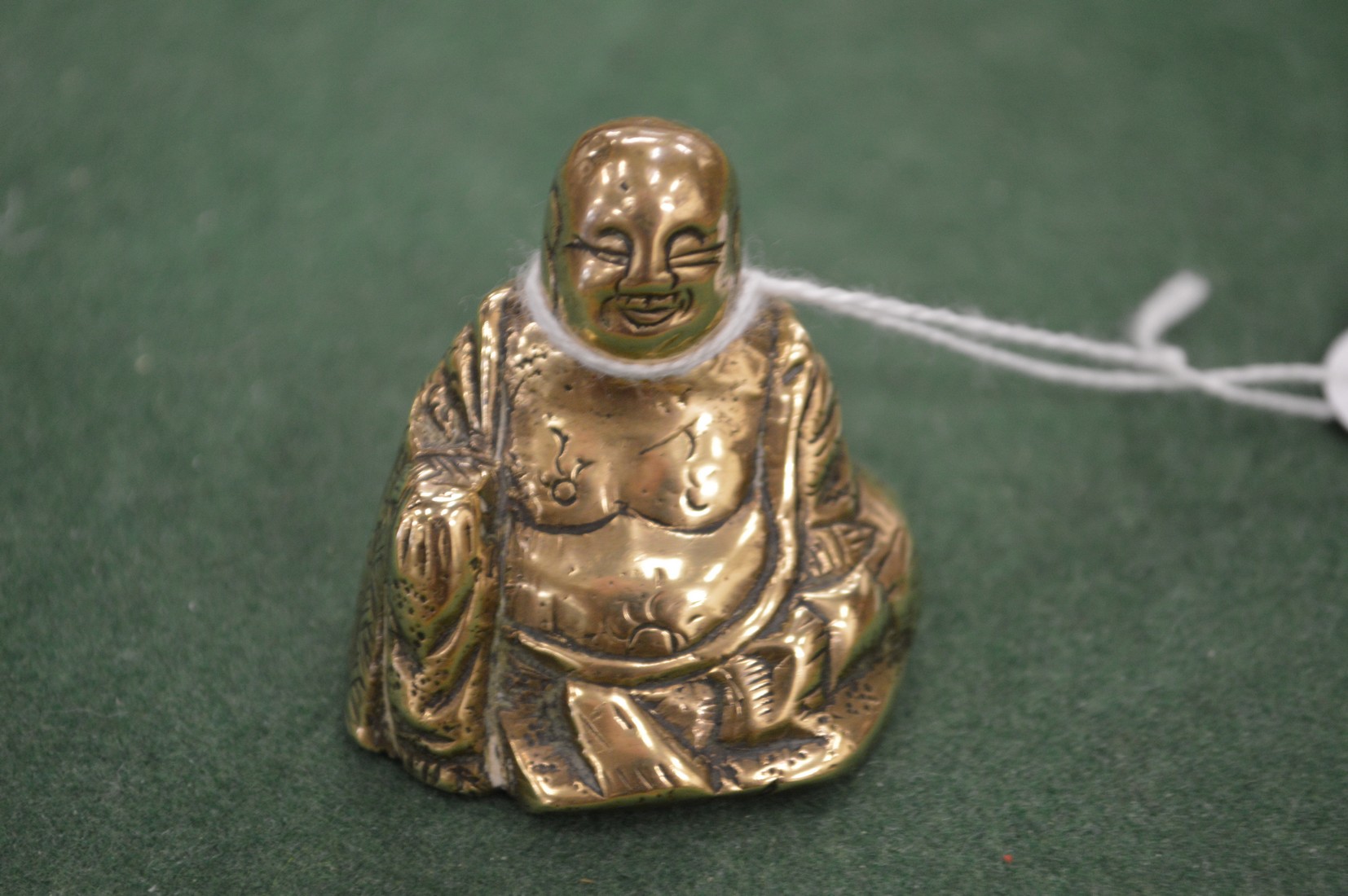 A miniature bronze Buddha.