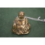 A miniature bronze Buddha.