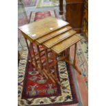 A nest of four walnut tables.