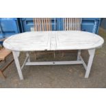 An oval painted wooden garden / patio table.
