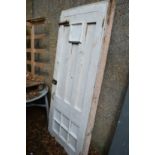 A white painted wooden door with door frame.