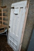 A white painted wooden door with door frame.