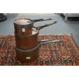 A good set of three Victorian copper saucepans with lids.