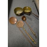 Two brass saucepans, an engraved copper ladle and two skimmers.