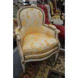 A French style cream painted and upholstered armchair.