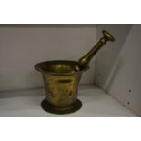 A brass pestle and mortar.